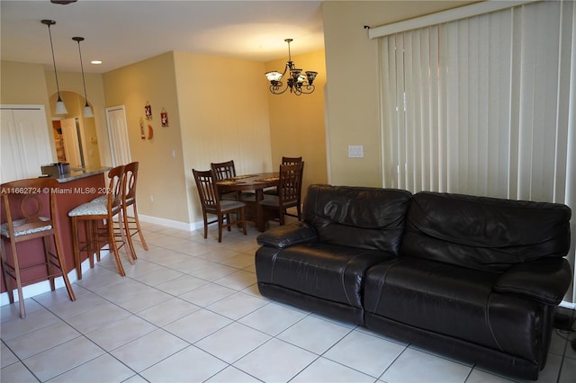 living room with a notable chandelier and light tile patterned floors