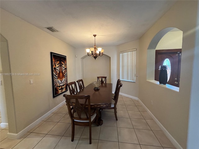 dining area with an inviting chandelier and light tile patterned floors