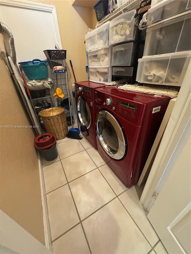 laundry area featuring light tile patterned floors and washing machine and dryer