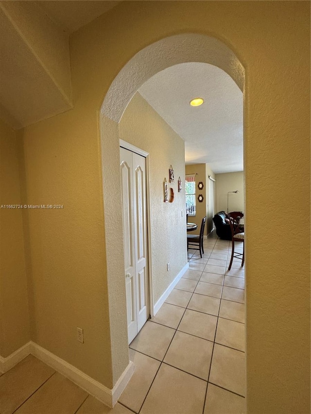 corridor featuring light tile patterned floors