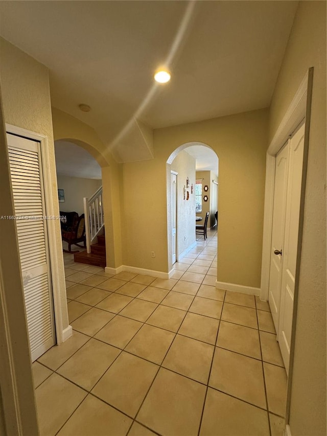 hall featuring light tile patterned flooring