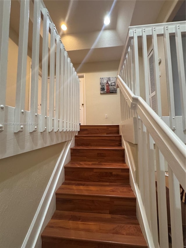 stairway with hardwood / wood-style flooring