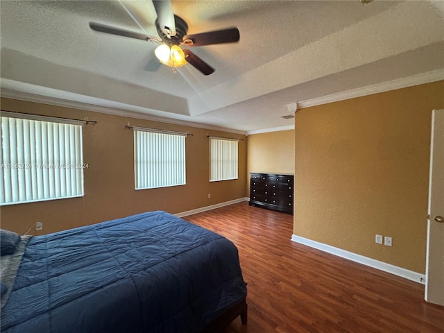 bedroom with a textured ceiling, hardwood / wood-style flooring, lofted ceiling, crown molding, and ceiling fan