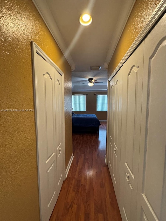 hall featuring crown molding and dark hardwood / wood-style flooring