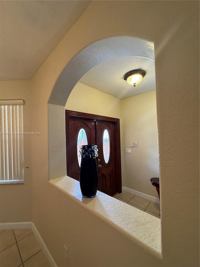 foyer entrance featuring light tile patterned floors