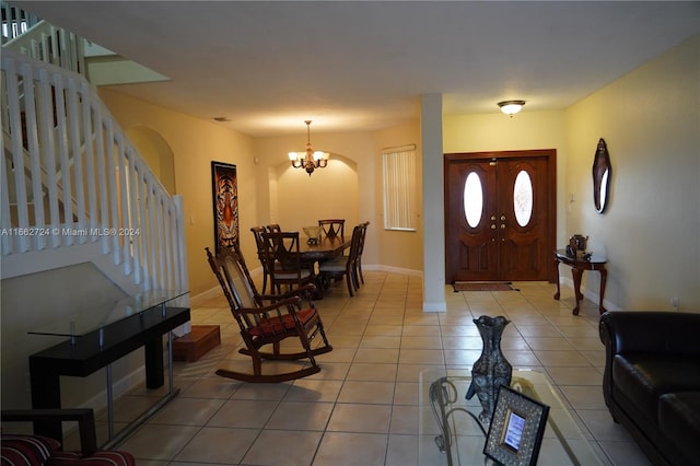 entrance foyer featuring a chandelier and tile patterned floors