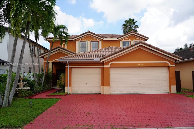 mediterranean / spanish-style house with a garage