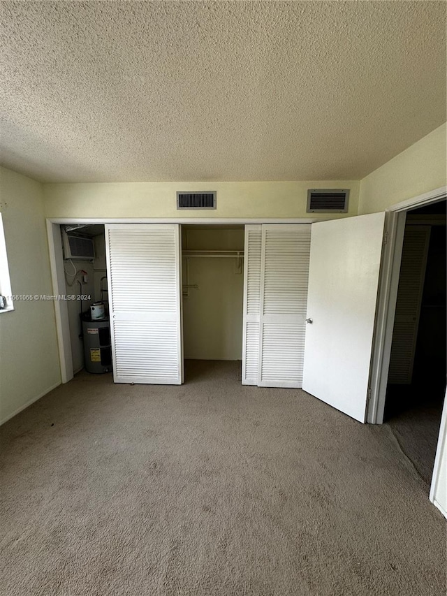 unfurnished bedroom with carpet floors and a textured ceiling