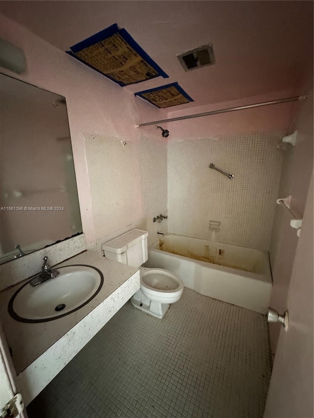 full bathroom featuring tile patterned flooring, sink, tiled shower / bath, and toilet