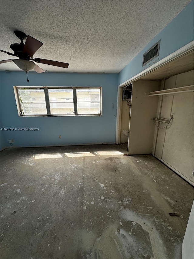 unfurnished bedroom featuring a closet, ceiling fan, and a textured ceiling