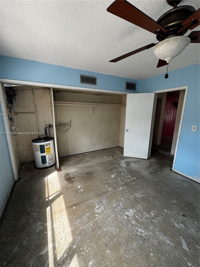 unfurnished bedroom with ceiling fan, water heater, a closet, and a textured ceiling