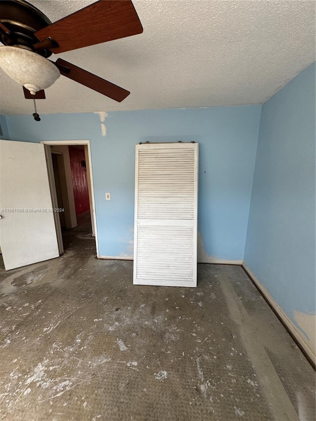 unfurnished bedroom with a textured ceiling and ceiling fan