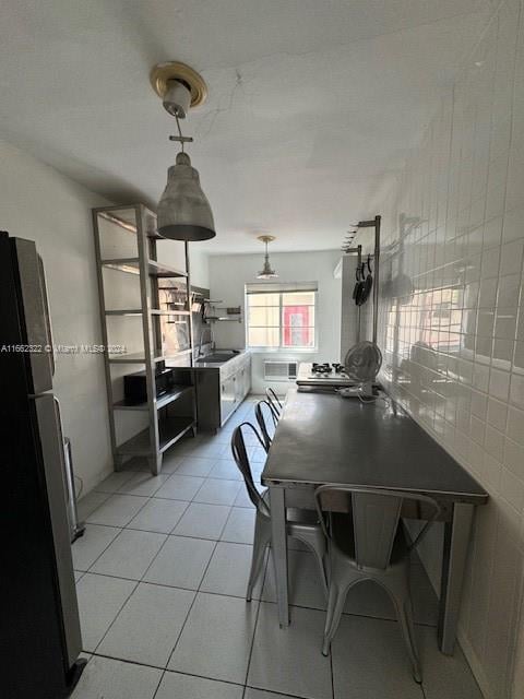 tiled dining area with tile walls and sink