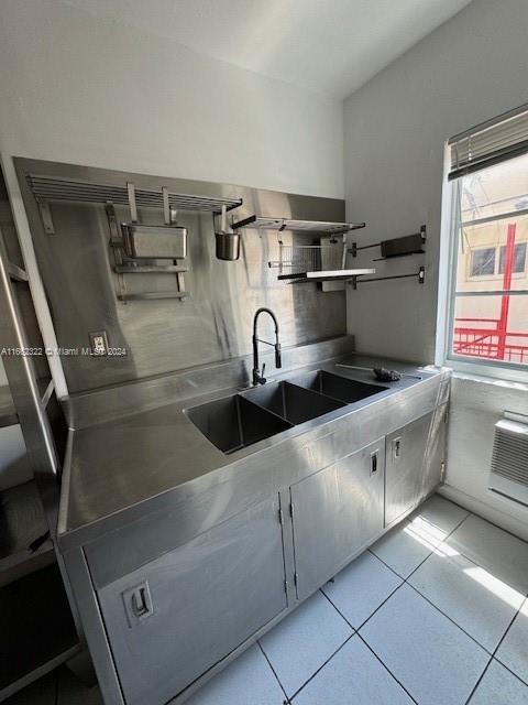 interior space featuring light tile patterned floors and sink