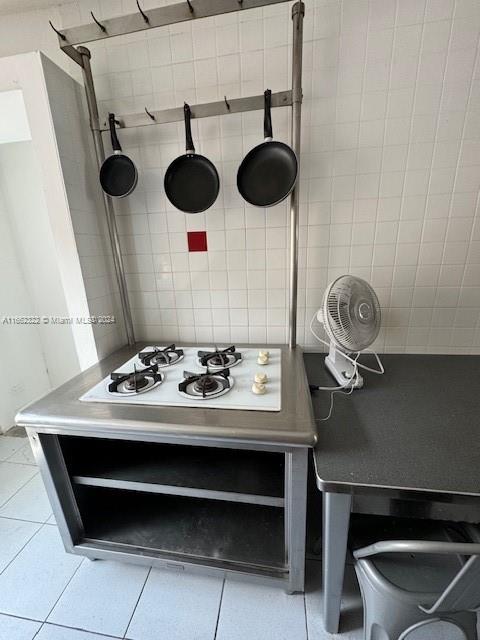 bathroom with tile walls and tile patterned floors