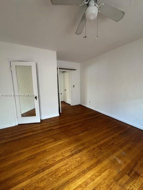 unfurnished bedroom with ceiling fan and dark hardwood / wood-style floors