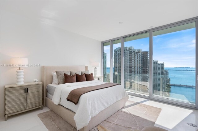 bedroom with a wall of windows and access to outside