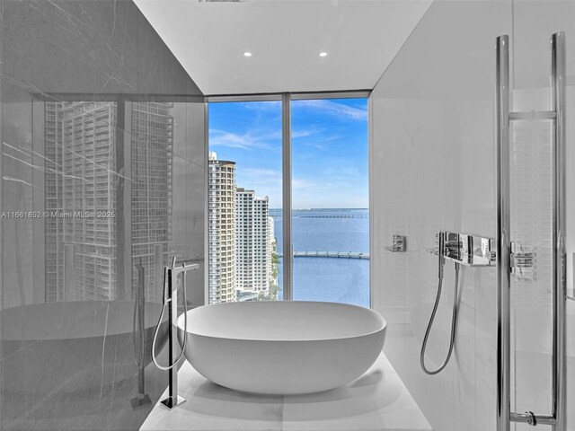 bathroom featuring a tile shower and vanity