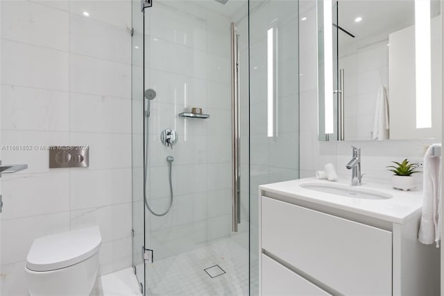 bathroom with vanity, a shower with shower door, tile walls, and toilet