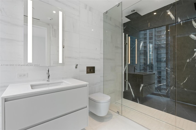 bathroom with tile walls, vanity, toilet, and walk in shower