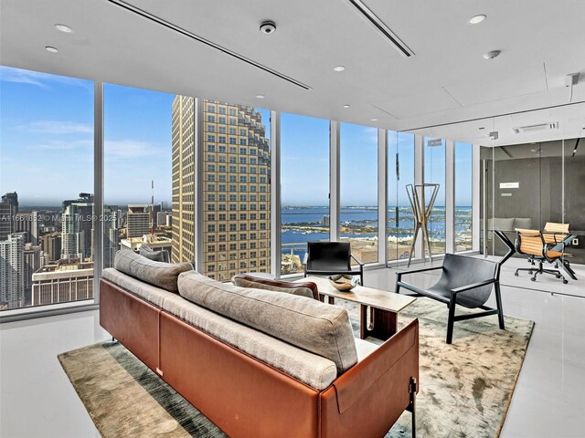 living room with floor to ceiling windows and a water view