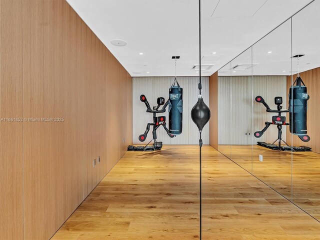 interior space with a water view, a wall of windows, and light hardwood / wood-style floors