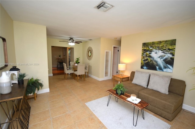 living room featuring light tile patterned floors and ceiling fan