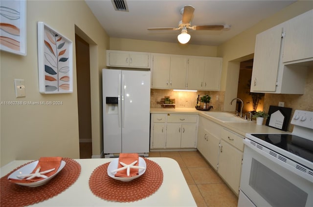 kitchen featuring light tile patterned floors, sink, white cabinets, white appliances, and ceiling fan