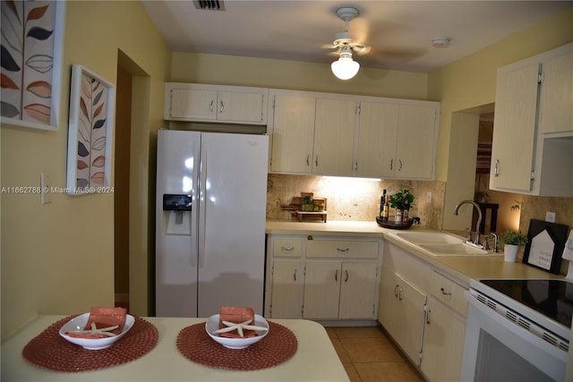 kitchen with tasteful backsplash, light tile patterned floors, sink, white appliances, and ceiling fan