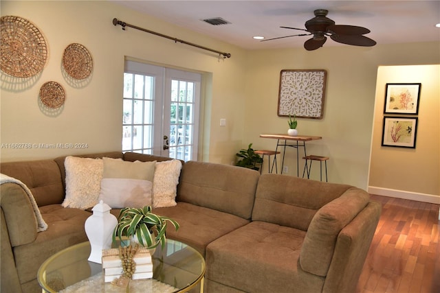 living room with wood-type flooring and ceiling fan