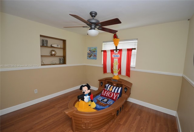 interior space featuring hardwood / wood-style floors, built in features, and ceiling fan