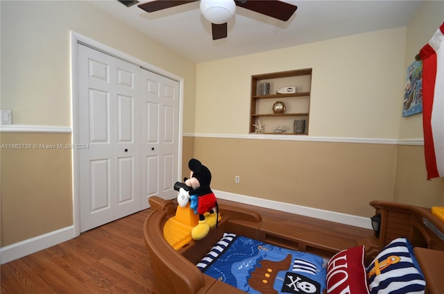 bedroom featuring ceiling fan, a closet, and wood-type flooring