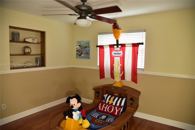 living area featuring dark hardwood / wood-style flooring and ceiling fan