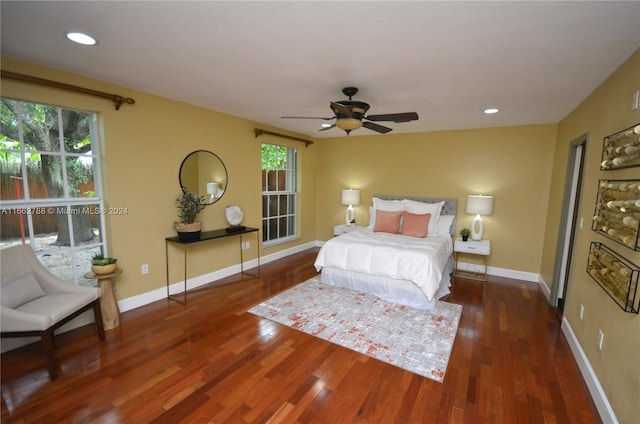 bedroom featuring ceiling fan and dark hardwood / wood-style floors