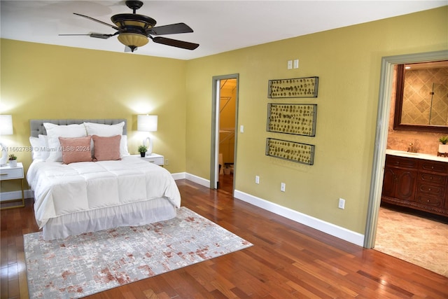 bedroom featuring hardwood / wood-style floors, ensuite bathroom, and ceiling fan