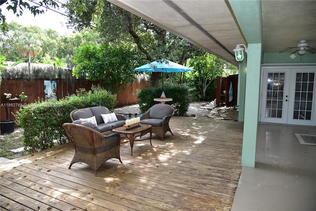 wooden terrace featuring an outdoor hangout area, french doors, and ceiling fan