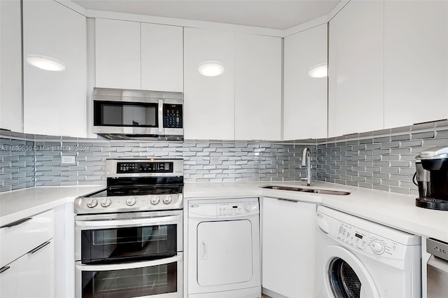 kitchen featuring white cabinets, washer / clothes dryer, and appliances with stainless steel finishes