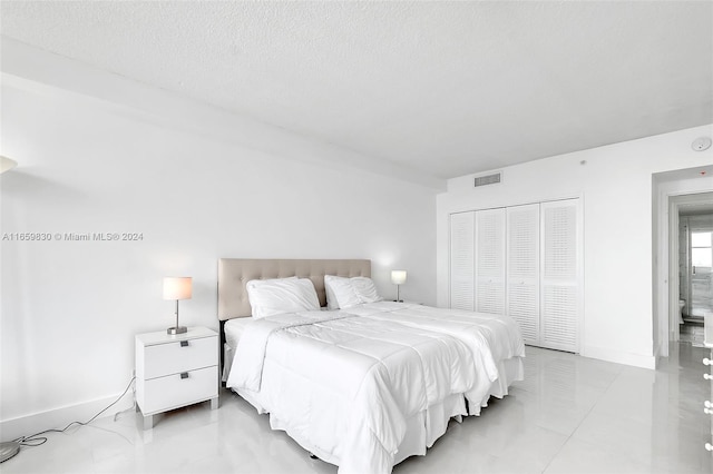 bedroom featuring a closet and a textured ceiling