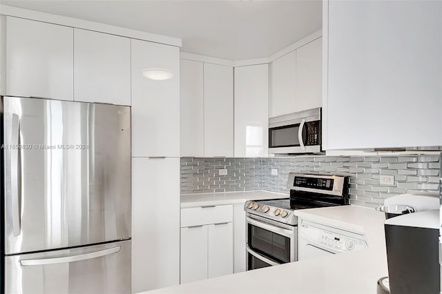 kitchen with appliances with stainless steel finishes, decorative backsplash, and white cabinets