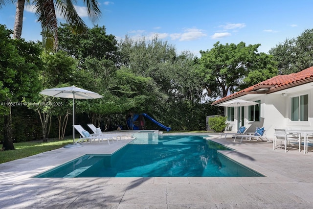 outdoor pool with a patio area