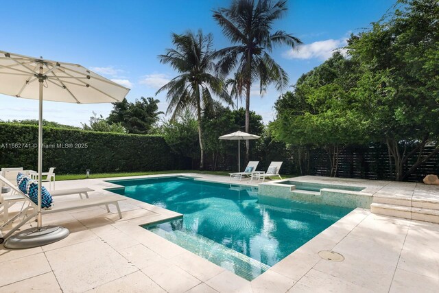 view of pool featuring an in ground hot tub and a patio area