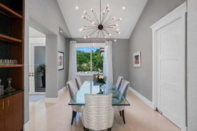 dining room with light tile patterned floors, lofted ceiling, and a chandelier