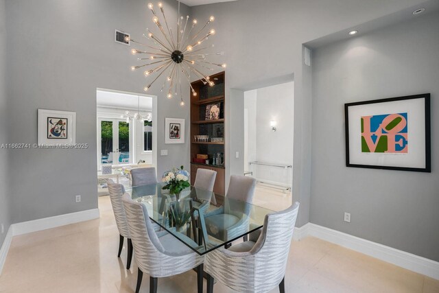 dining room featuring a notable chandelier, built in shelves, and french doors