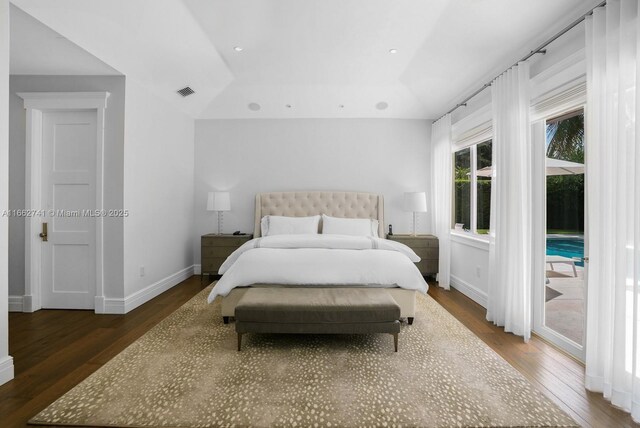 bedroom with access to outside and dark wood-type flooring