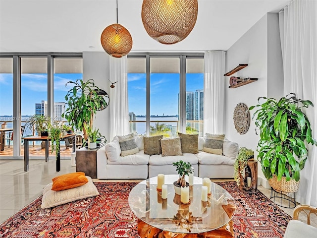 living room featuring a wall of windows and a water view