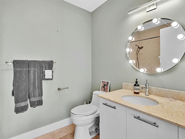 bathroom featuring tile patterned flooring, vanity, and toilet