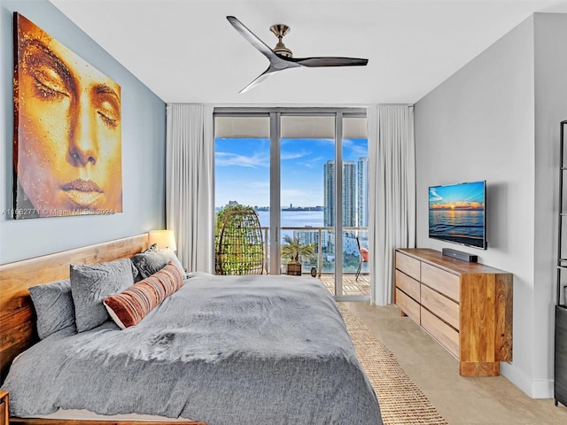 tiled bedroom featuring ceiling fan, a wall of windows, and access to exterior