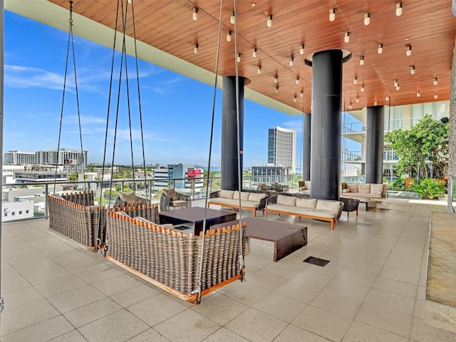 view of patio with an outdoor living space with a fire pit