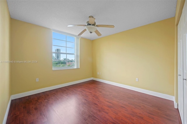 empty room featuring ceiling fan, a textured ceiling, and hardwood / wood-style floors