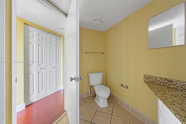 bathroom with vanity, hardwood / wood-style floors, and toilet